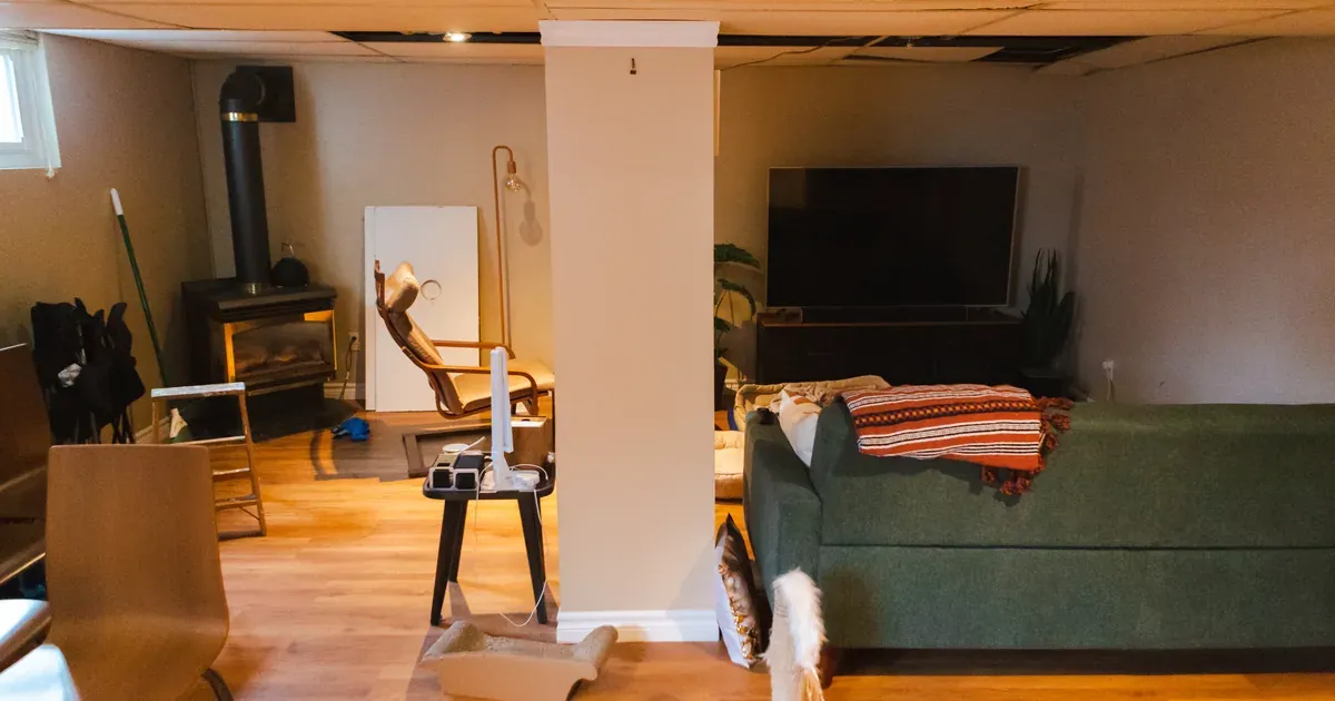 A well-organized garage with wall shelving, pegboard tool storage, and clear labeled bins — floor cleared, bikes mounted, everything in its zone.