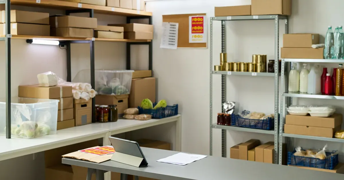 A well-organized garage with wall-mounted shelves, labeled bins, and clear floor space. Natural light, real home setting.