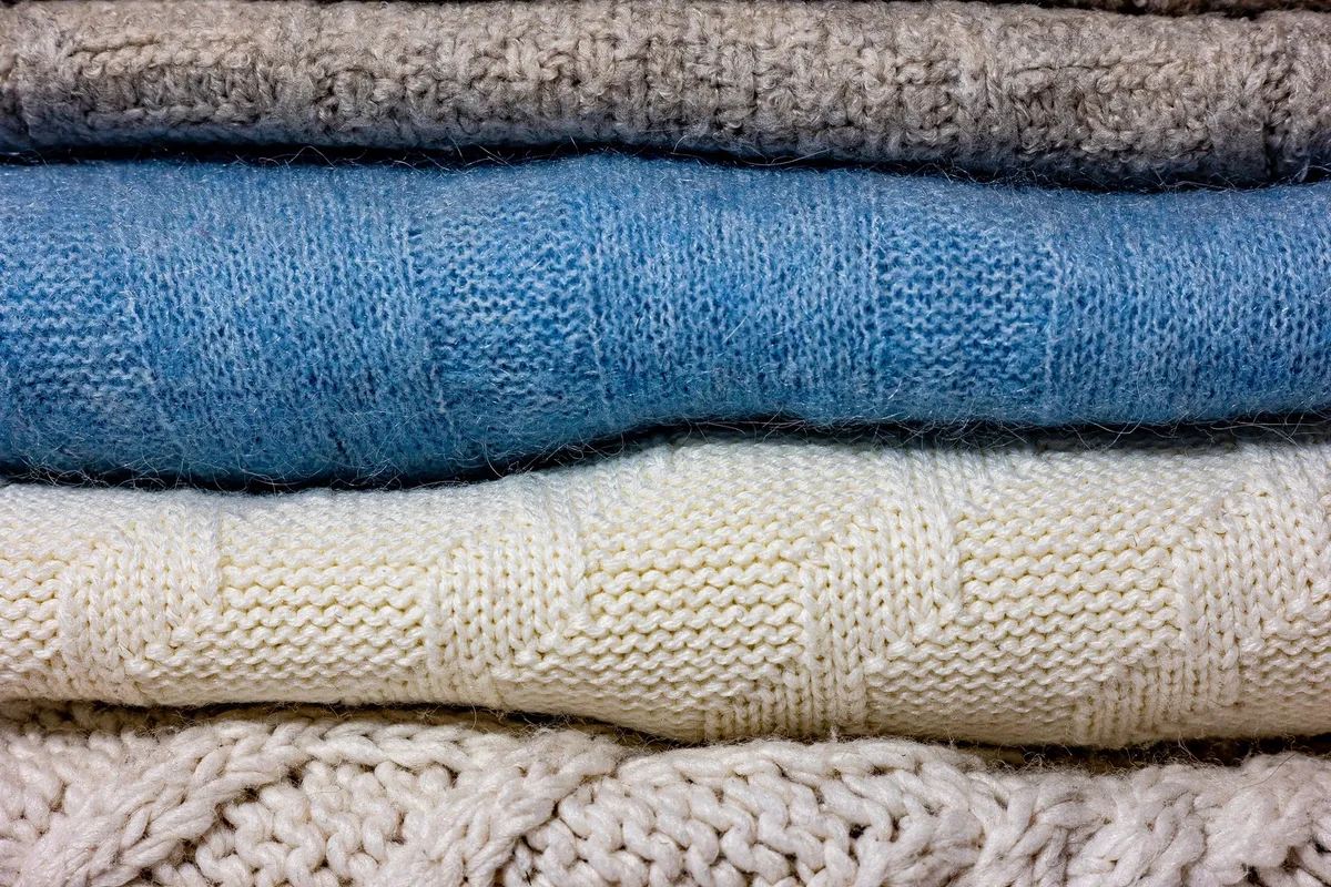 hanging cubby organizer with folded sweaters and jeans
