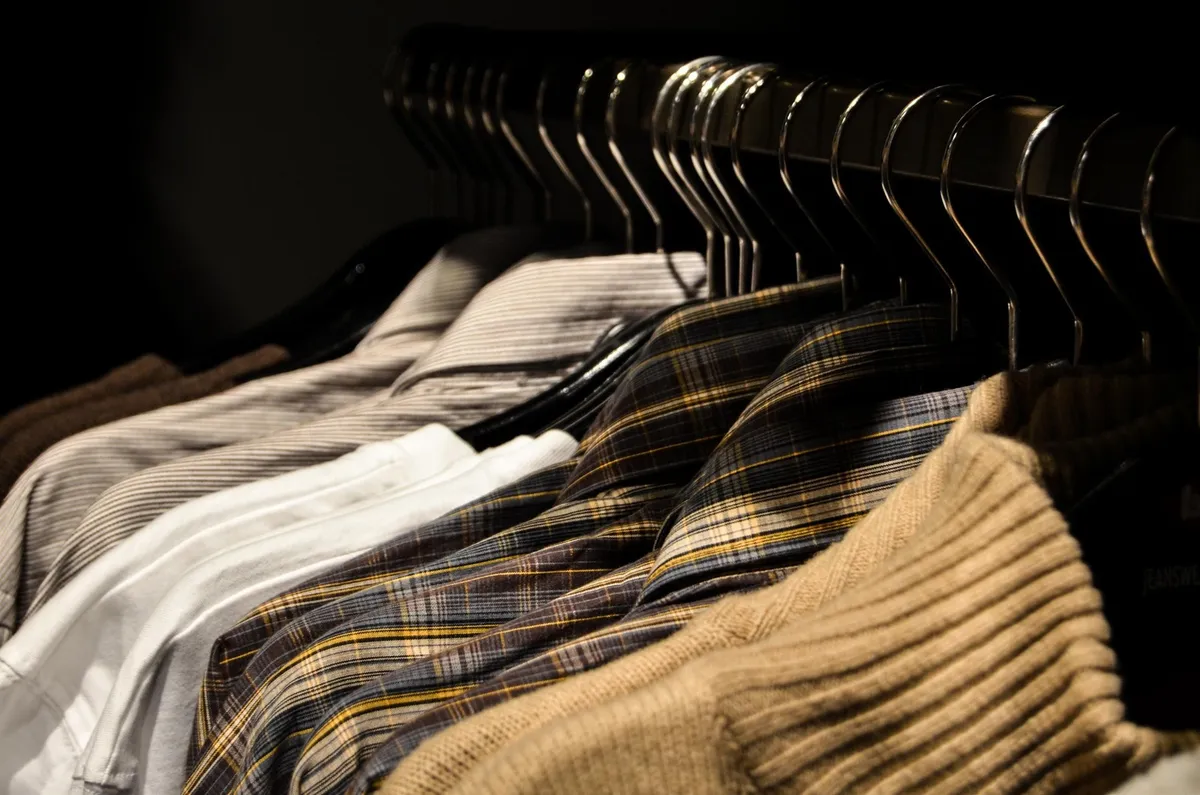 open cube shelf with neatly folded sweatshirts in fabric bins