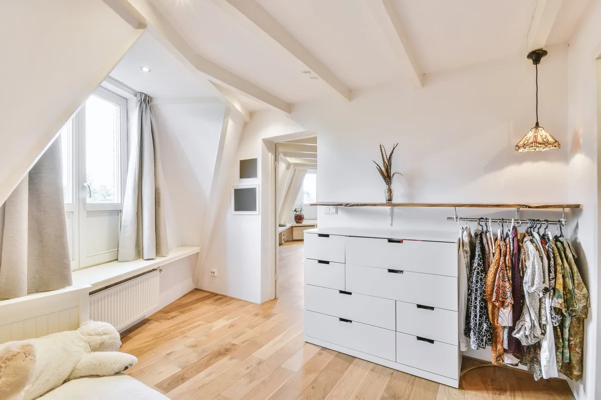 closet with double hanging rod holding shirts and jackets