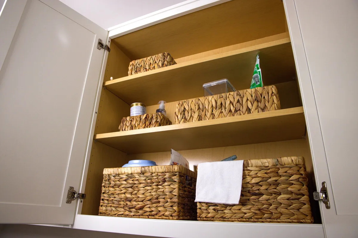 bedroom with labeled donate box and trash bags ready