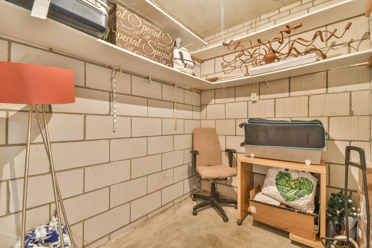 overhead ceiling storage platform in garage with large plastic storage totes
