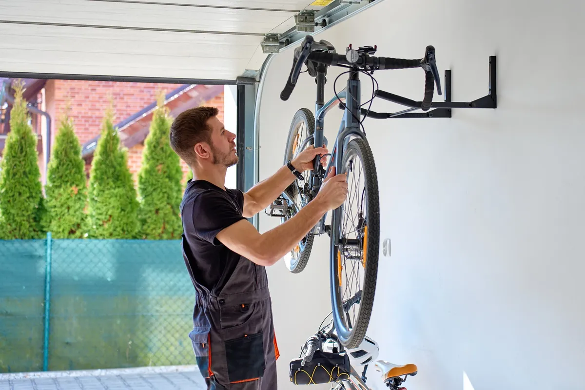bike hanging vertically from wall hook in garage