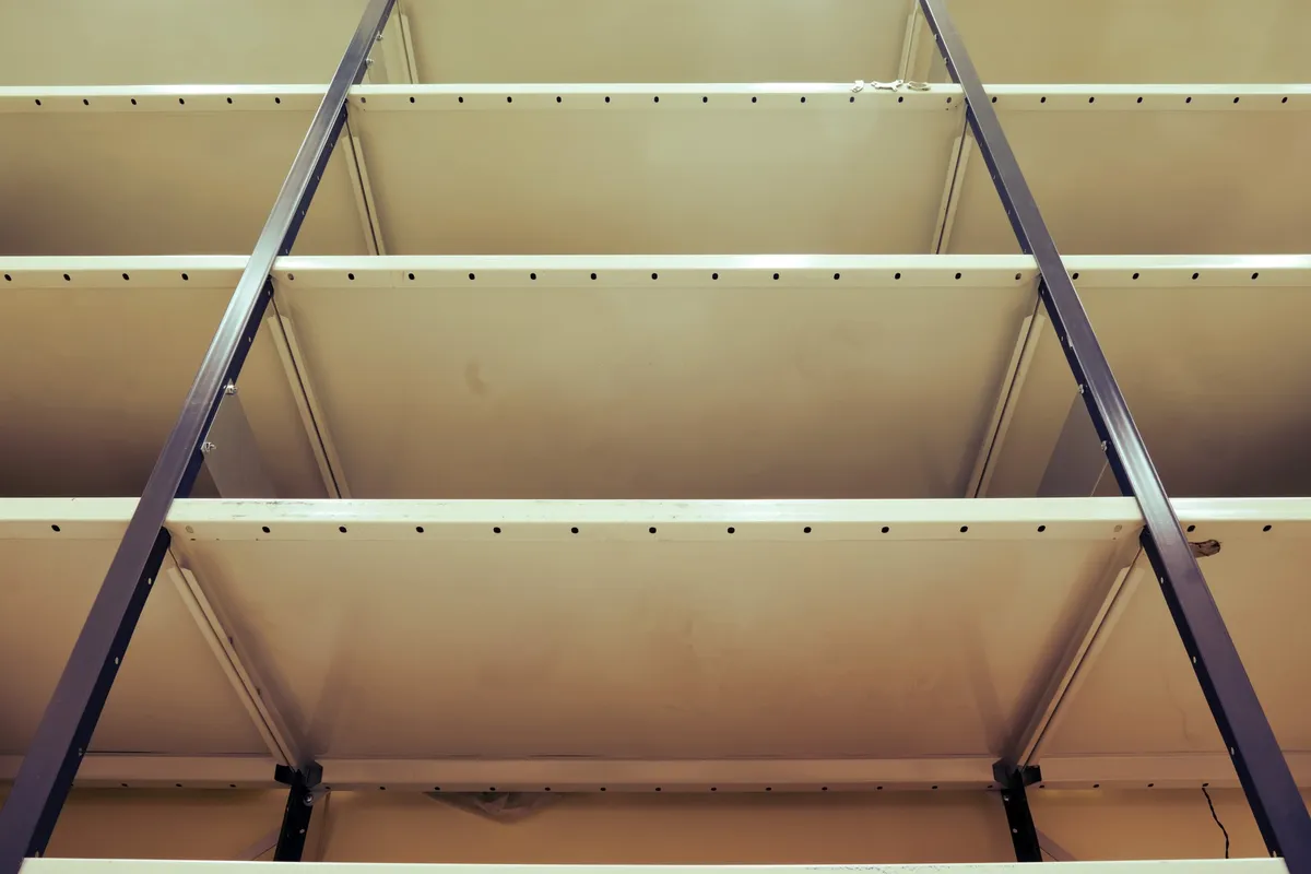 freestanding metal wire shelving unit in garage with storage bins