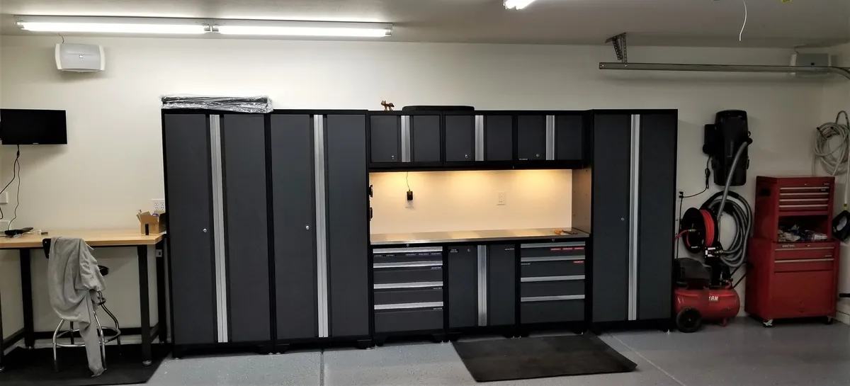 wall mounted bracket shelving in garage with labeled bins