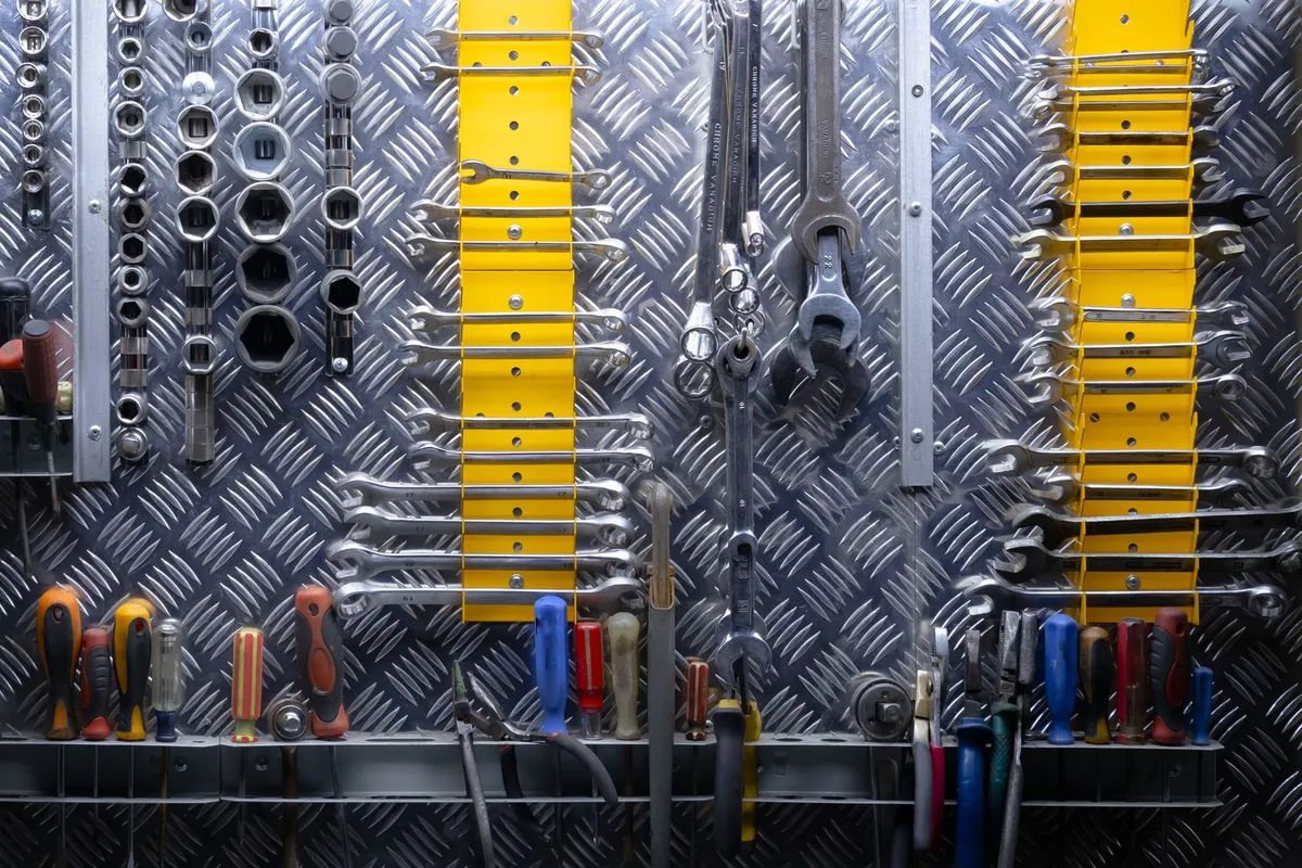 metal garage storage cabinets along wall with closed doors and workbench nearby