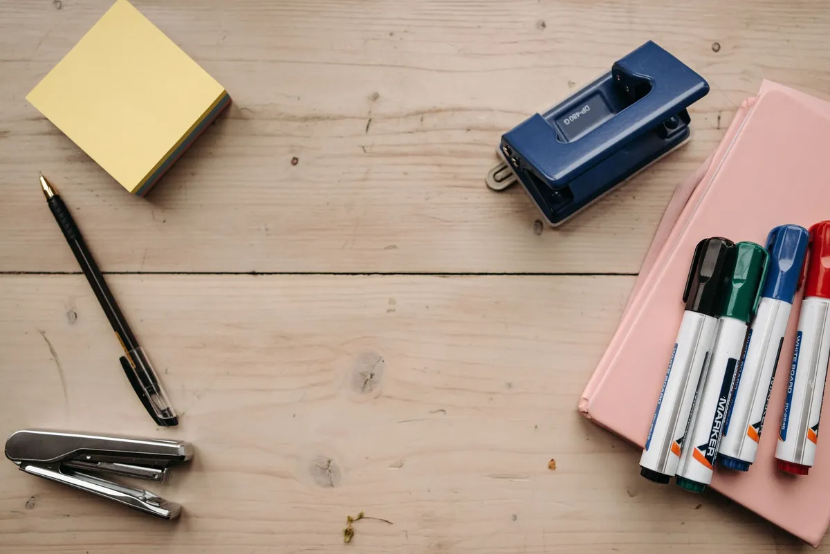 bamboo desktop organizer with pens and scissors on wood desk