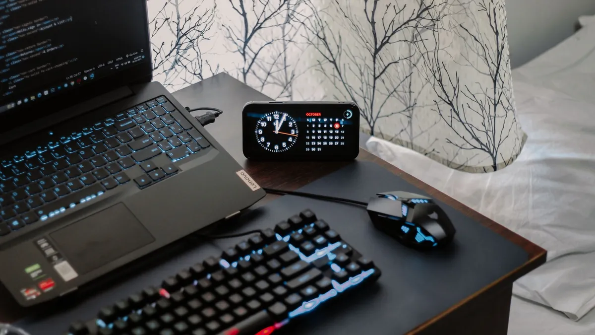 two monitors side by side on wooden desk with keyboard