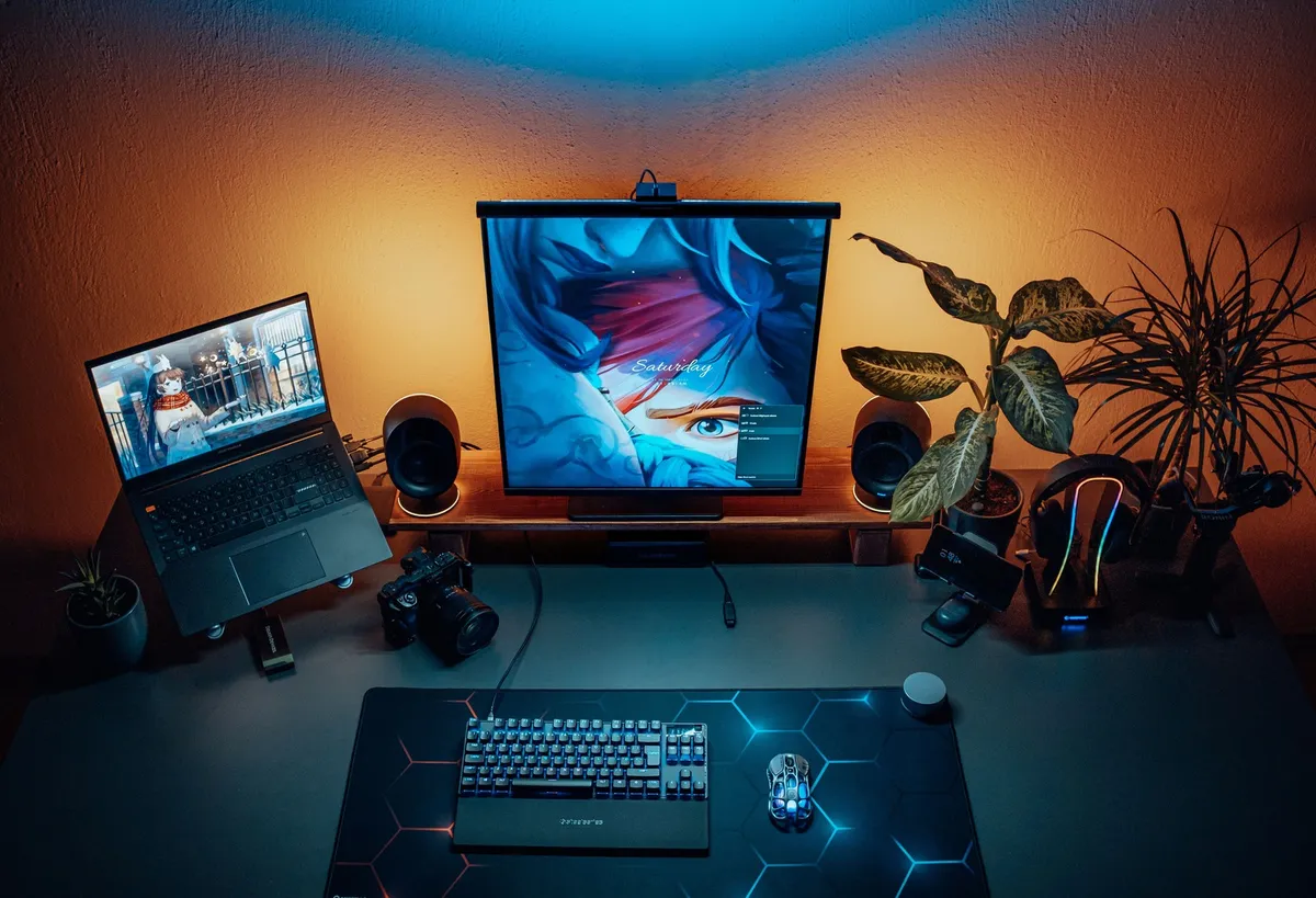 small corner desk with monitor notebook and minimal supplies