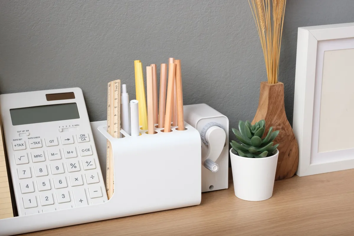 floating shelves above desk with labeled binders and small plant
