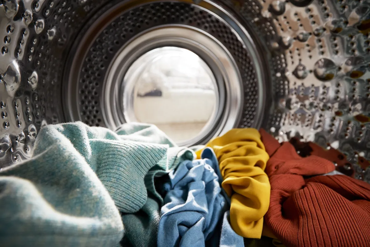clean washing machine drum open with white drum interior