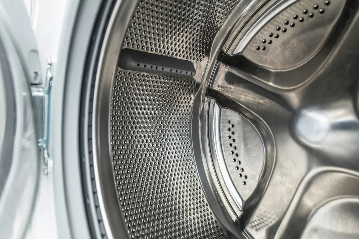 clean washing machine drum open with white drum interior