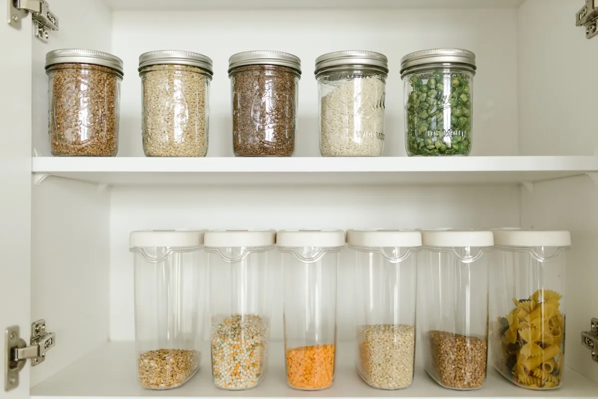 large clear cereal containers with silicone lid on pantry shelf