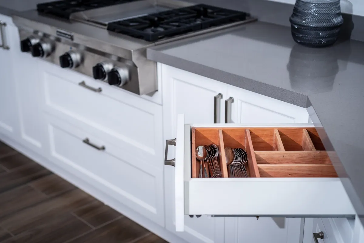 wire shelf risers inside base cabinet with stacked pots and pans