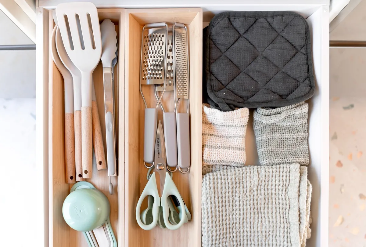 kitchen pegboard wall with hanging pots and utensils