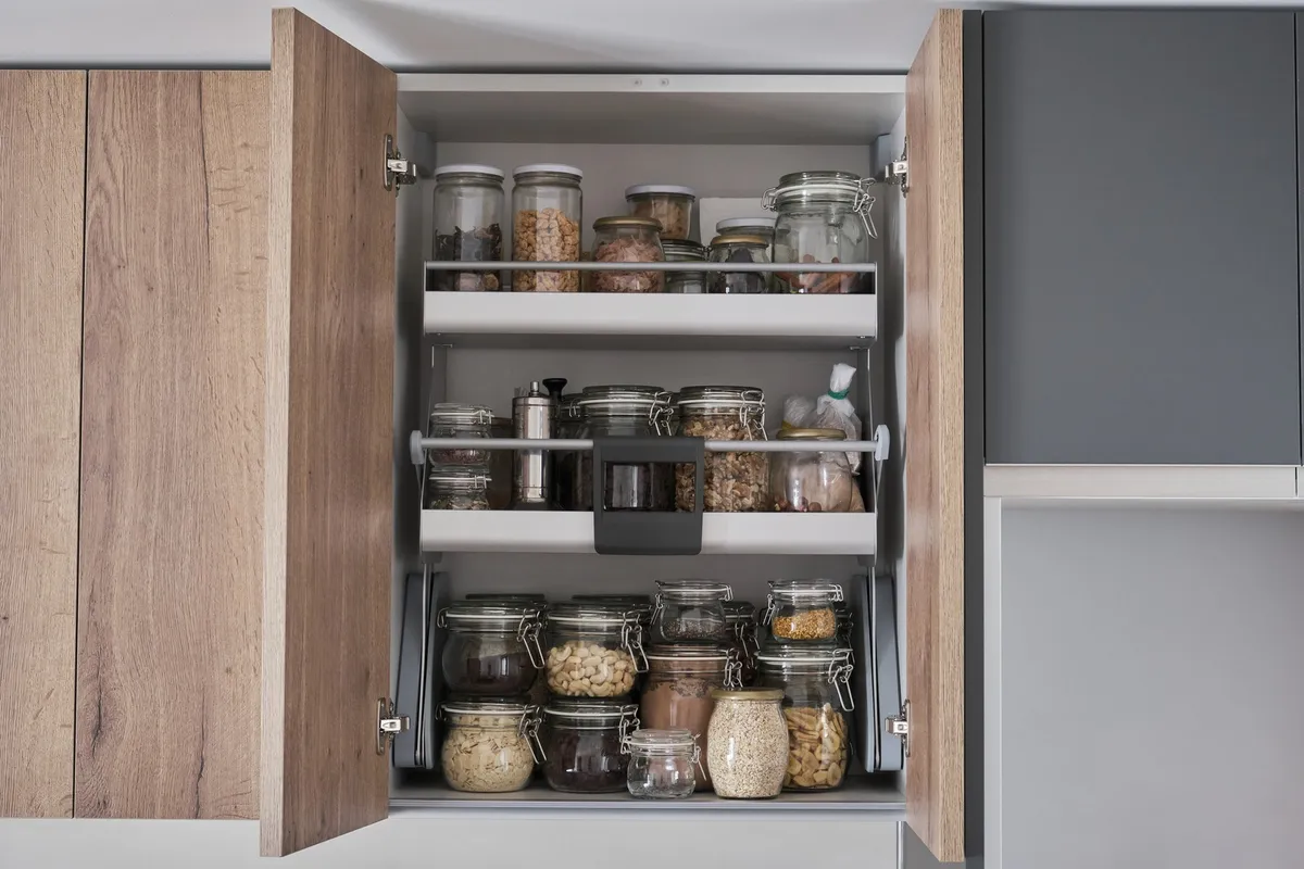 pull-out pantry tower extended from wall cabinet space showing tiered shelves