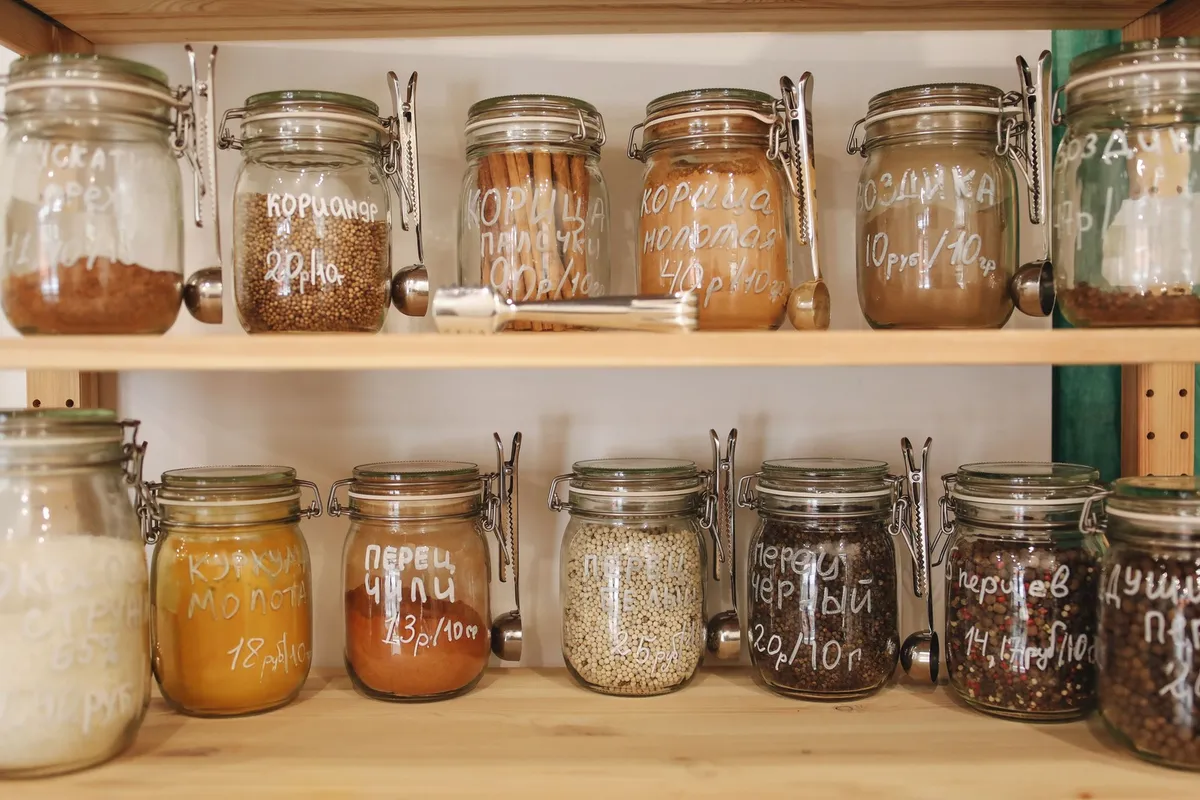 white freestanding pantry cabinet with adjustable shelves and organized food items