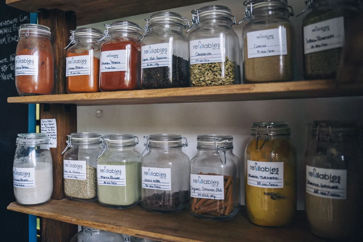 tall armoire pantry cabinet open showing organized interior shelves and door organizers