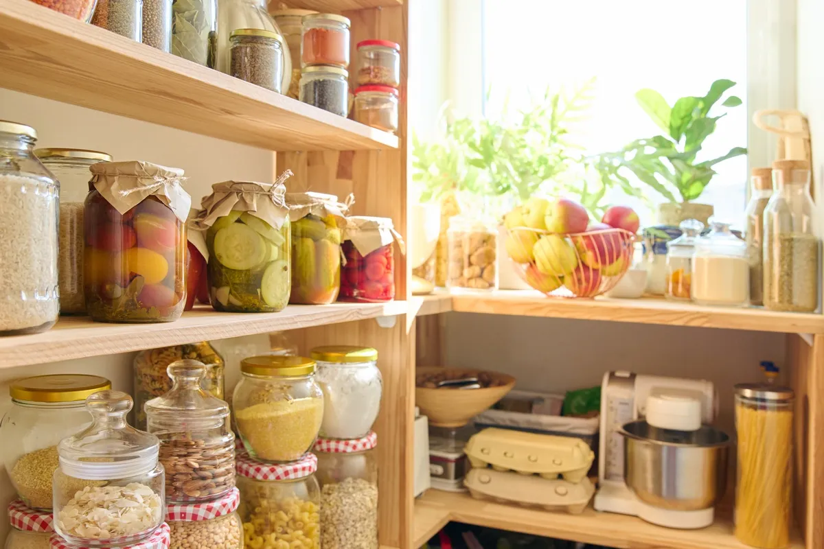 white freestanding pantry cabinet with adjustable shelves and organized food items