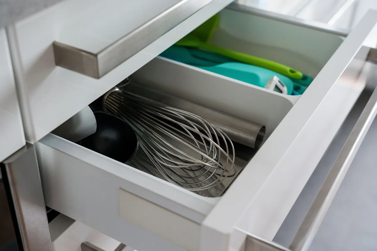 cabinet shelf riser holding stacked plates and bowls