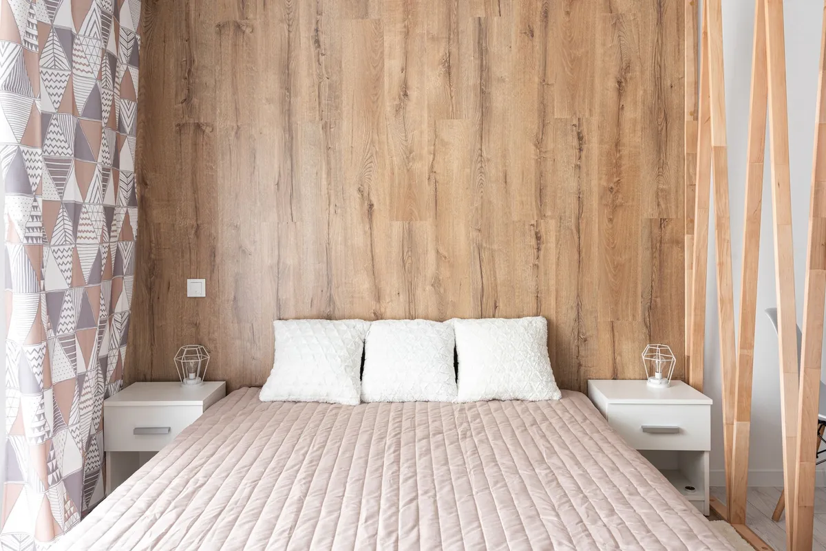 bed frame with open storage drawers showing folded bedding inside