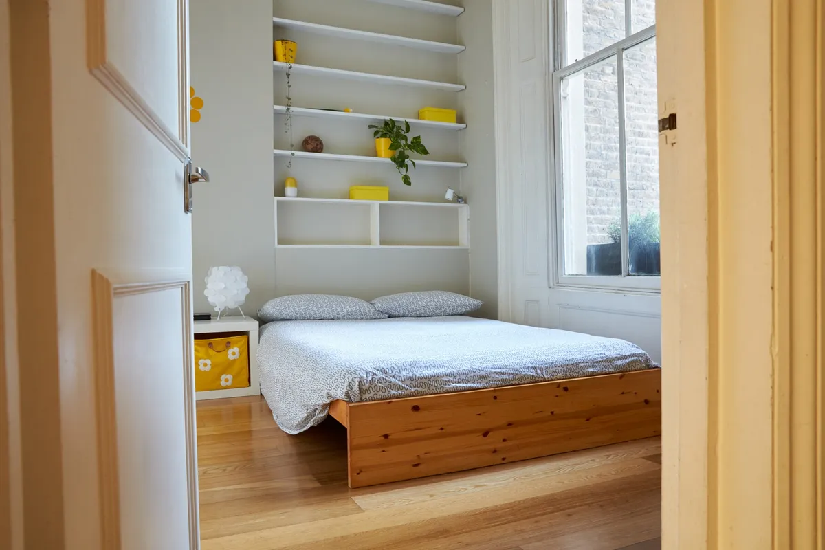 over-door pocket organizer on white bedroom door with accessories