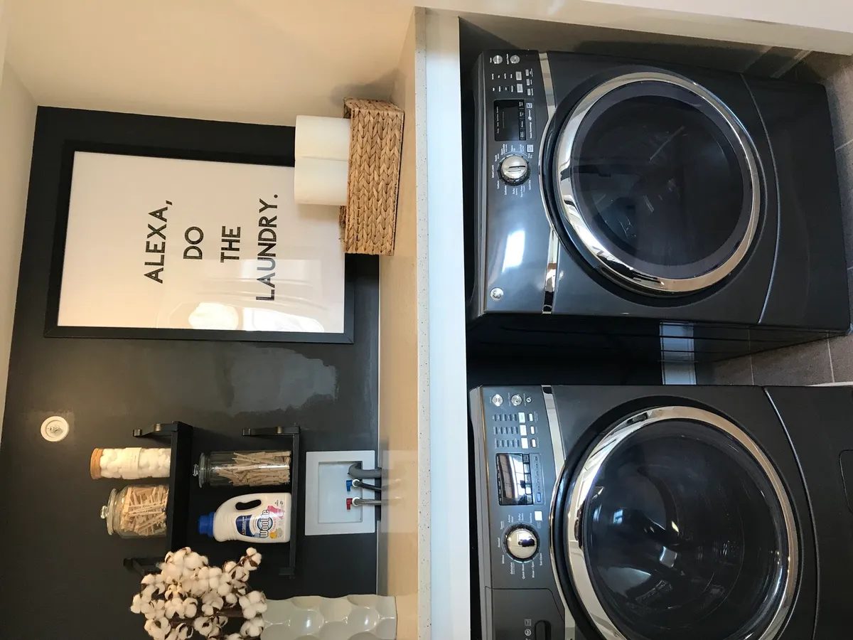 tension rod holding hung shirts in laundry closet
